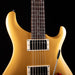 Gold electric guitar on a black background
