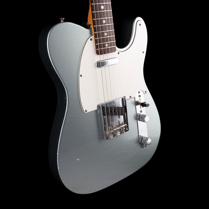 Silver electric guitar on a black background