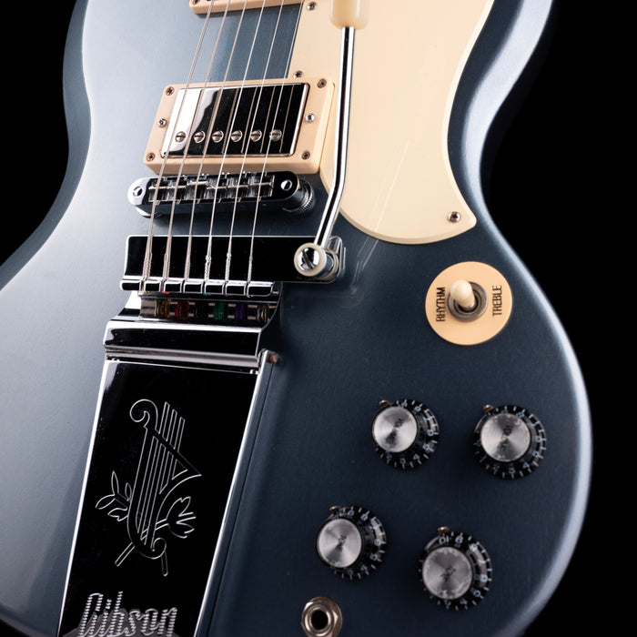 Close-up of a Gibson electric guitar with focus on the neck and control knobs.