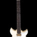 White electric guitar with a black pickguard on a white background