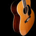 Acoustic guitar with a dark brown finish on a black background
