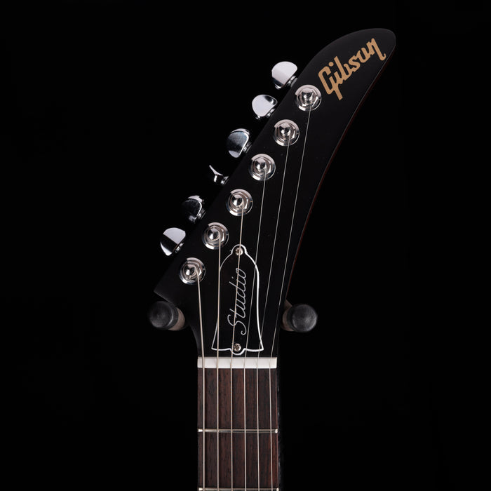 Gibson guitar headstock with brand name on a black background