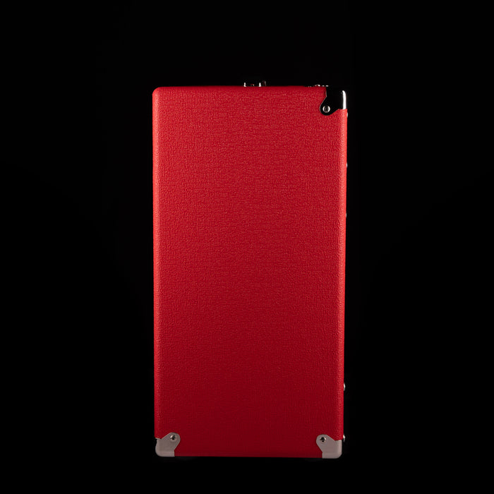 Red rectangular box with a textured surface on a black background