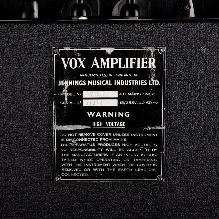 VOX amplifier with warning label on a black background