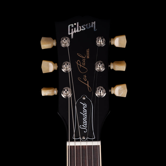 Gibson Les Paul guitar headstock with brand name on a black background