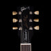 Gibson Les Paul guitar headstock with brand name on a black background