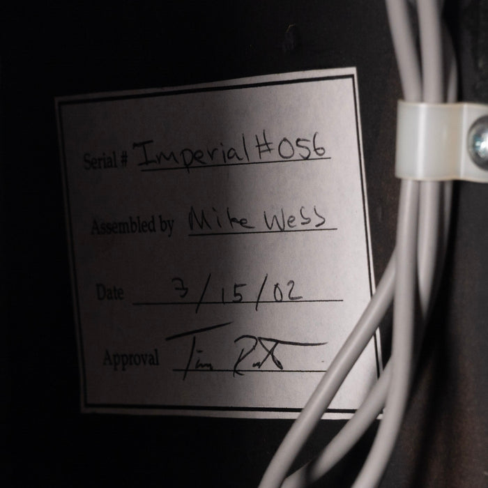 Label with handwritten text on a dark background