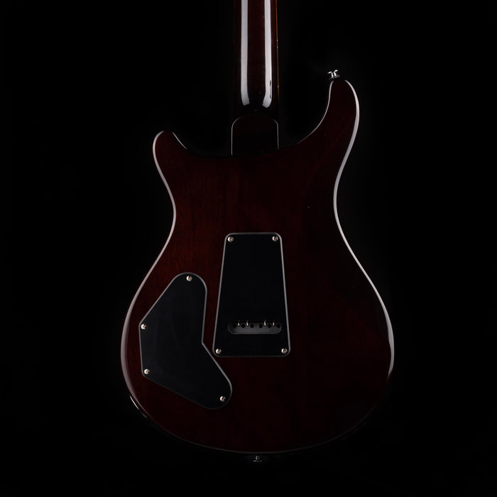 Dark brown electric guitar on a black background