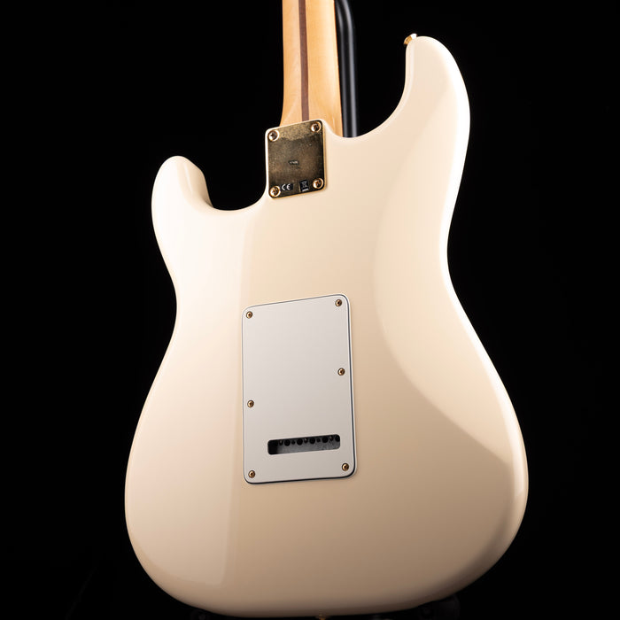 White electric guitar body with a visible brand logo on a black background