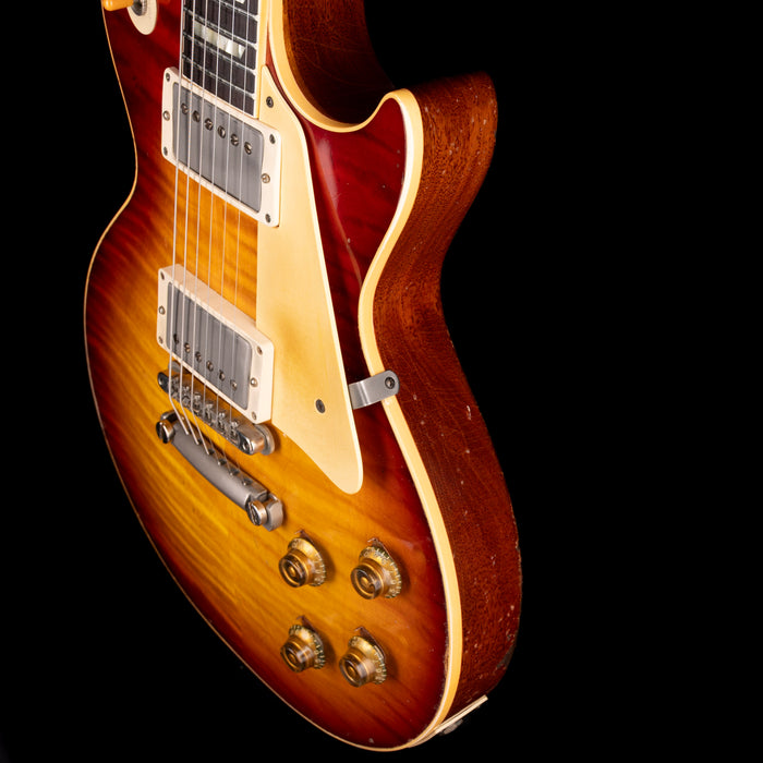 Close-up of a sunburst electric guitar on a black background