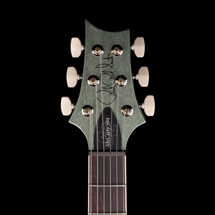 Guitar headstock with brand logo on a black background