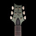 Guitar headstock with brand logo on a black background