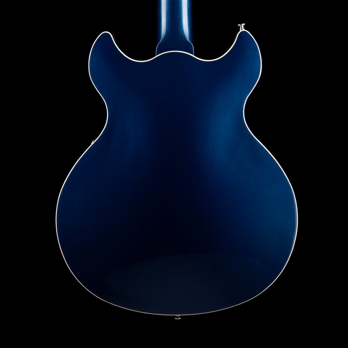 Blue electric guitar body on a black background