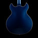 Blue electric guitar body on a black background