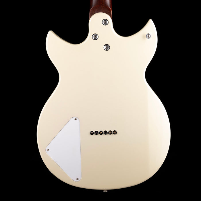 Back view of a cream-colored electric guitar on a black background