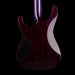 Purple electric guitar with a black pickguard on a black background
