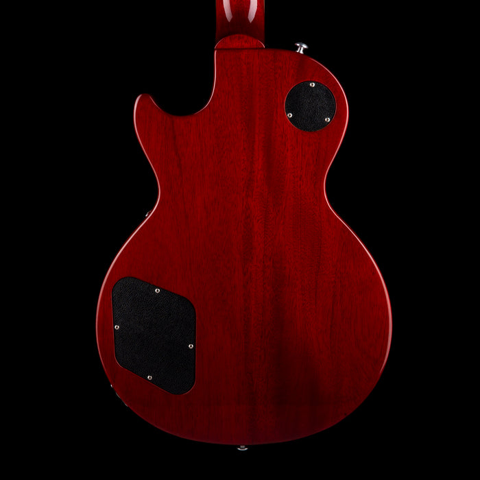 Red electric guitar body with black pickguard on a black background