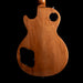 Back view of a wooden electric guitar on a black background