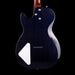 Back view of a blue electric guitar with a white pickguard on a black background