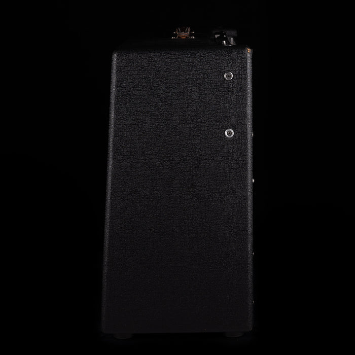 Black rectangular object with textured surface on a black background