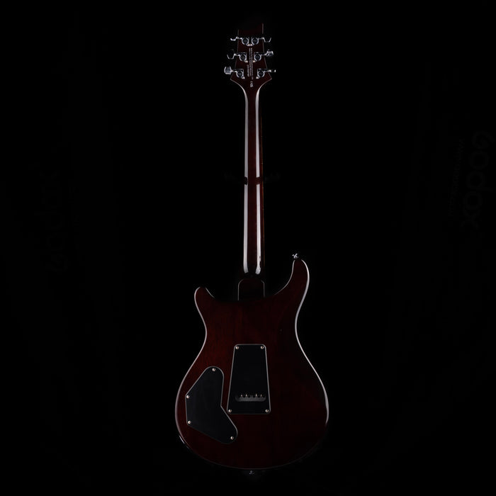 Dark brown electric guitar on a black background