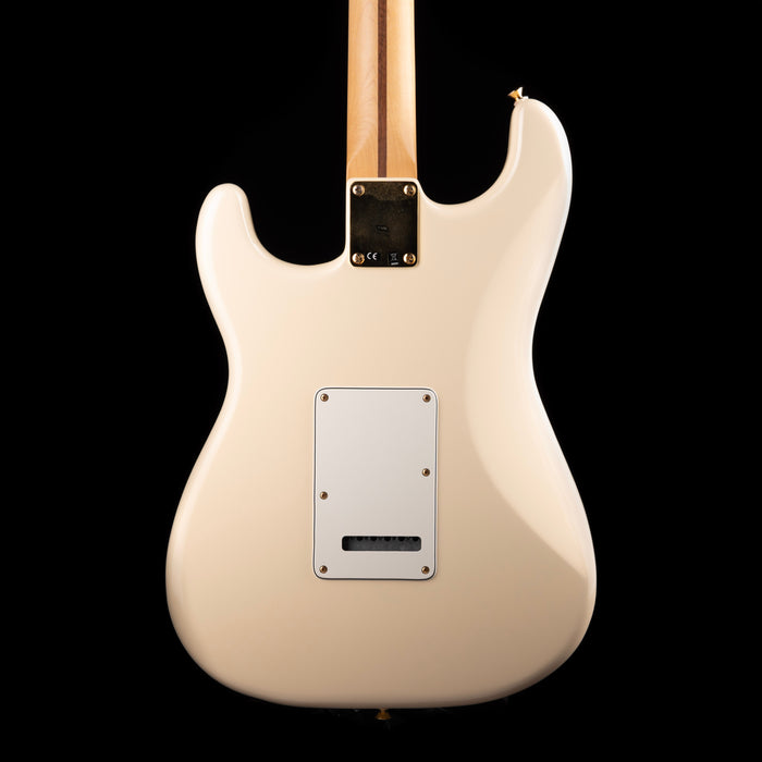 White electric guitar on a black background