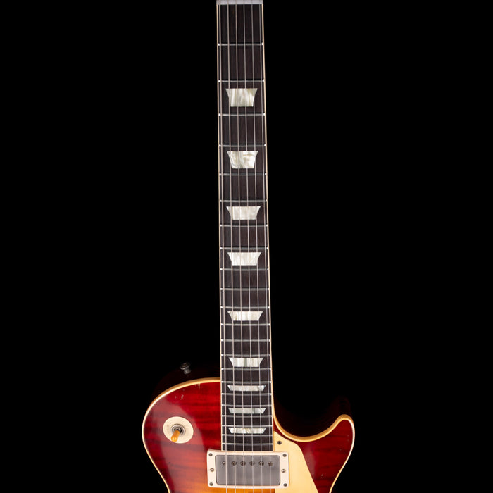 Electric guitar with a sunburst finish on a black background