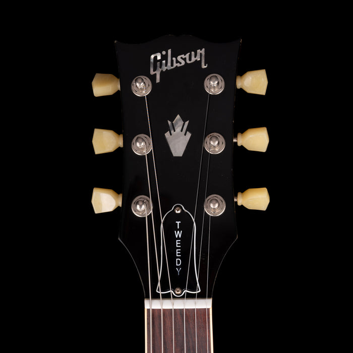 Gibson guitar headstock with 'Tweed' branding on a black background